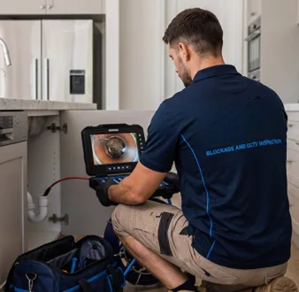 Clearing a blocked sink at a Darlinghurst property